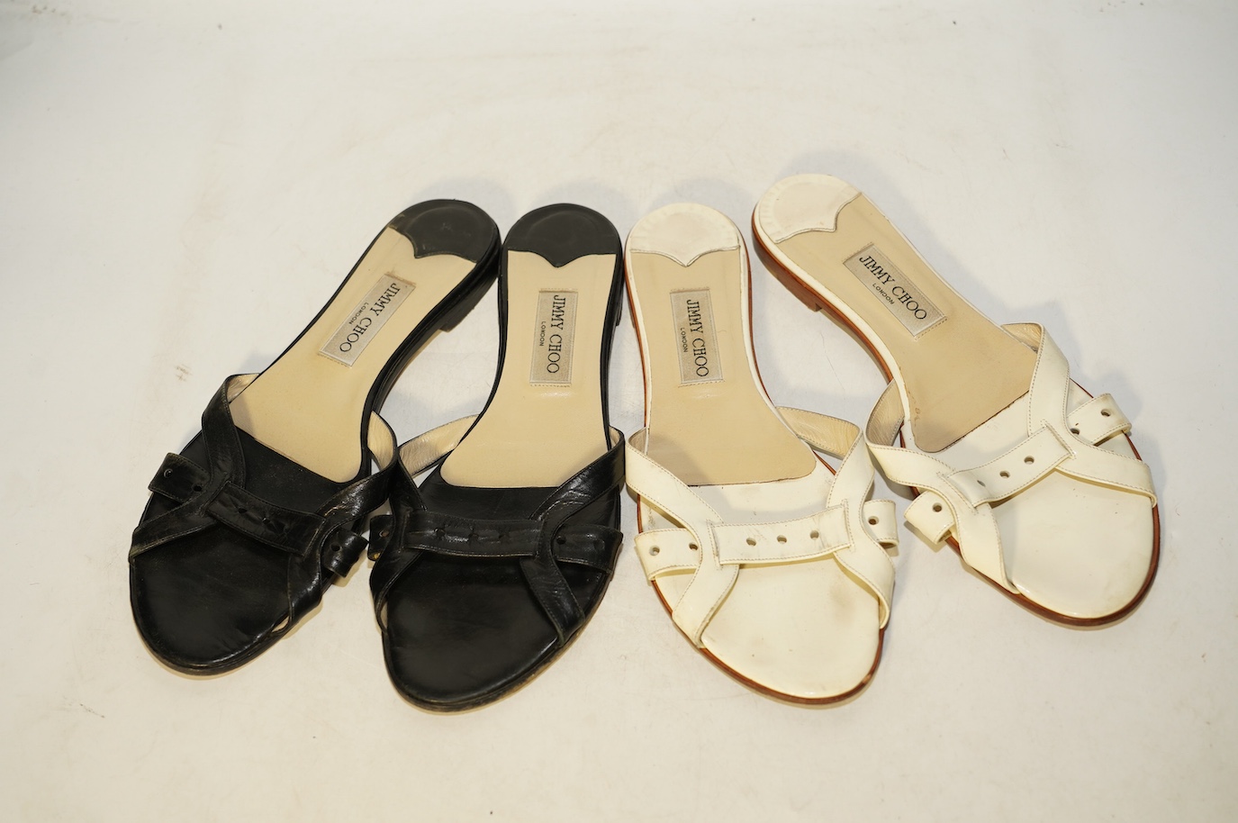 Two pairs of Jimmy Choo flat sandals, black leather and white patent leather, size 41